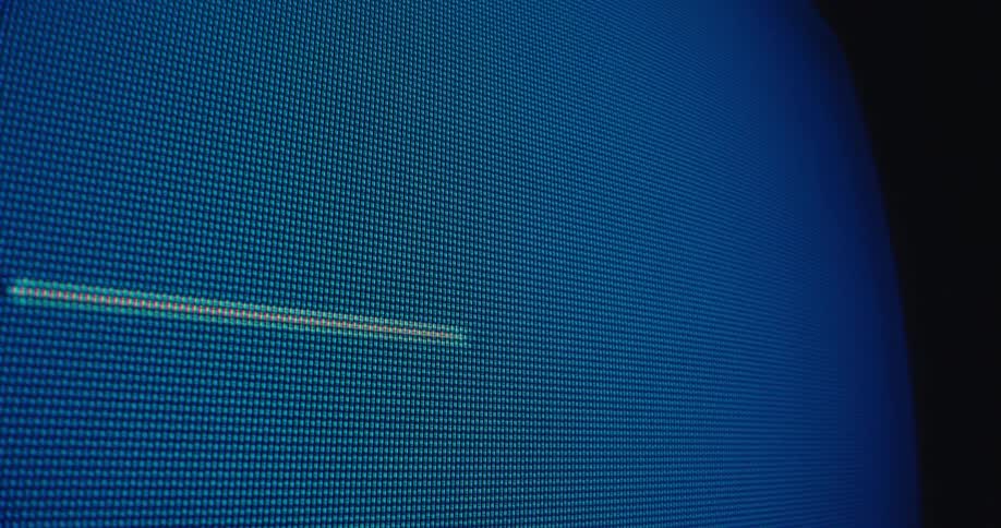 A horizontal glitch line appears on a blue digital screen