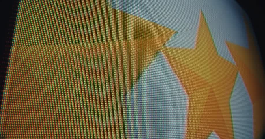 The individual pixels of a digital display showcasing the grid pattern that forms the image the camera pans across highlighting a bright orange starlike shape illustrating how these tiny elements combine to create a larger visual