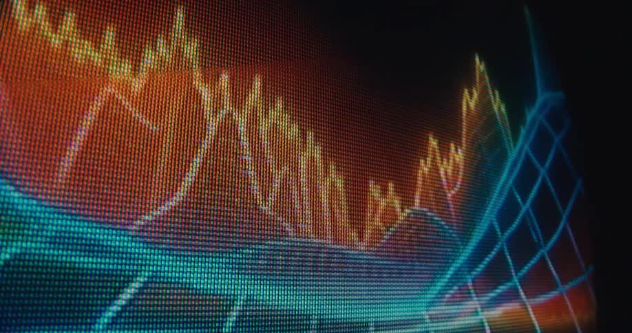 A closeup of a pixeled digital screen shows colorful animated data graphs and audio waveforms fluctuating against a dark background