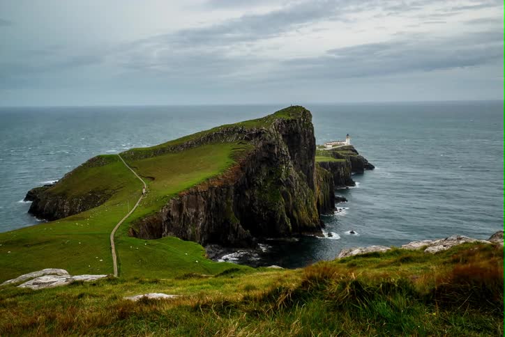 Ocean waves flow around cliffs on the coast