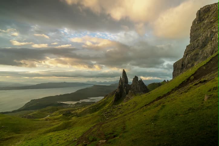 Clouds roll through the sky over mountains and hills