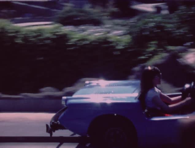 A girl rides in a car that is part of an amusement park ride