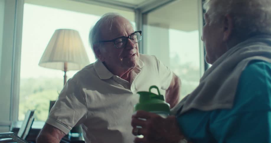 Elderly couple laughing together enjoying a joyful conversation