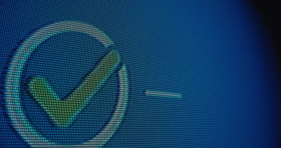 A closeup of a digital screen showing pixels that form a visual of a fingerprint scan as the scan progresses a loading bar fills culminating in a checkmark indicating successful authentication or completion