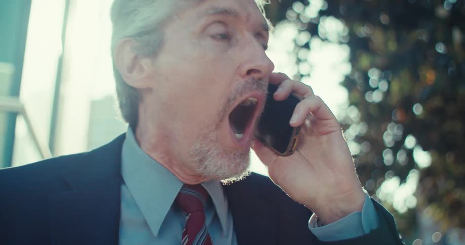 Man in suit walking talking on a call and being happy
