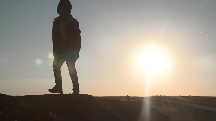A kid climbing up a hill