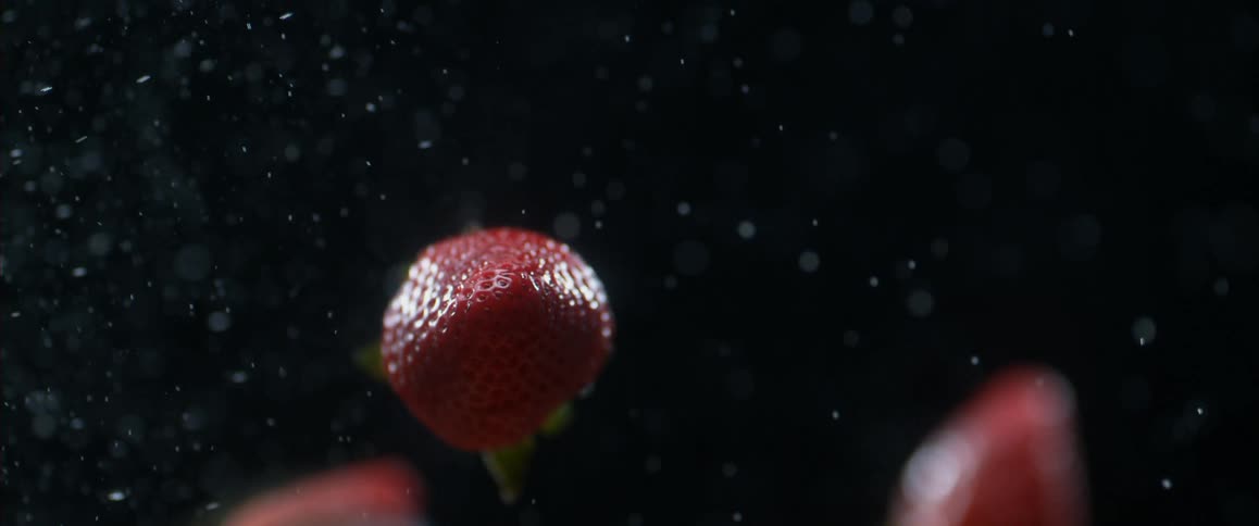 Close up of strawberries flying through the air