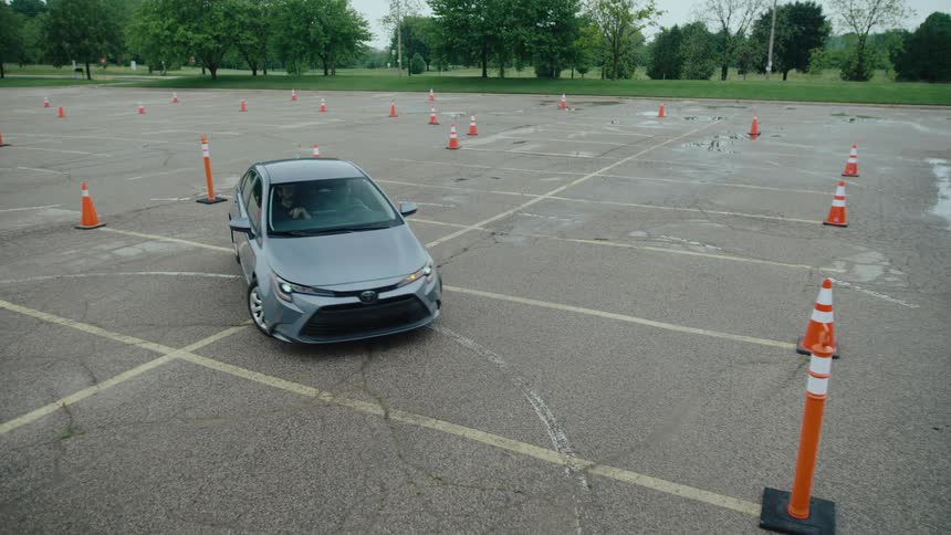 Sedan car being parked in an open space