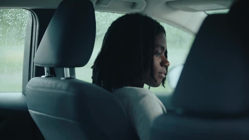 Woman inside a car with the windows closed from the rain
