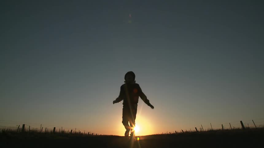 A person walking against the horizon
