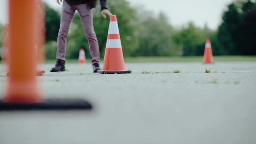 Person placing cones on a street