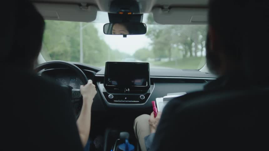 Driving lesson with instructor inside a moving car