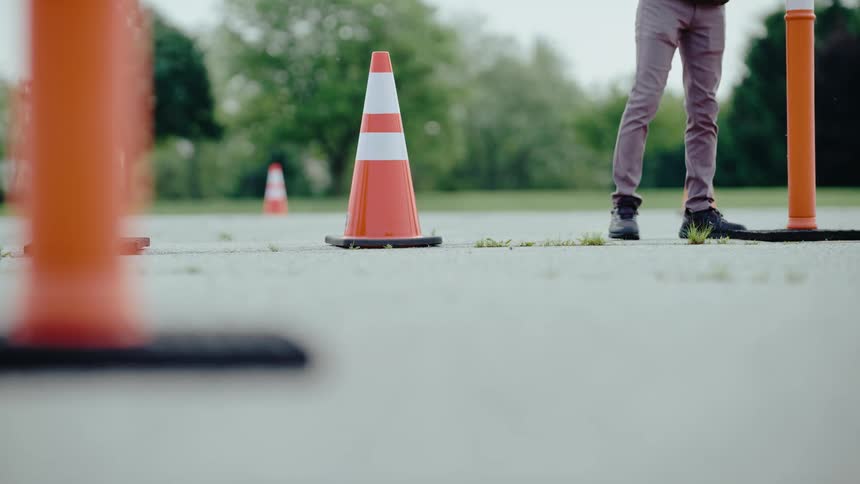 Person placing traffic cones in a parking lot