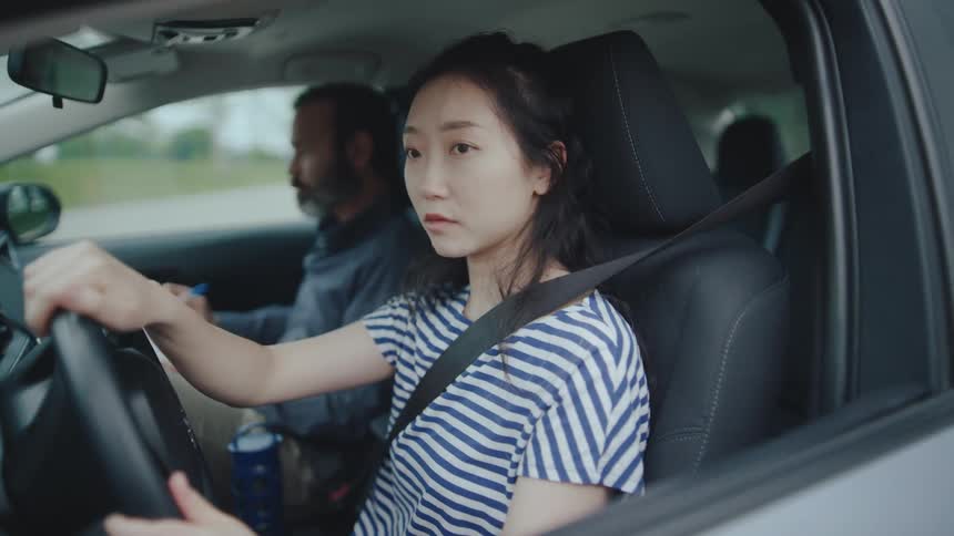 Young woman drives while man sits beside her