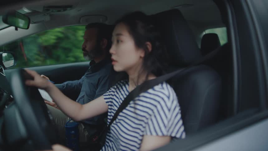 Woman driving a car accompanied by an examiner