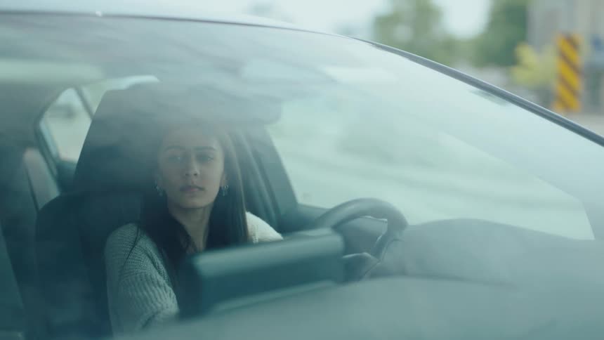 Concentrated woman maneuvering a vehicle