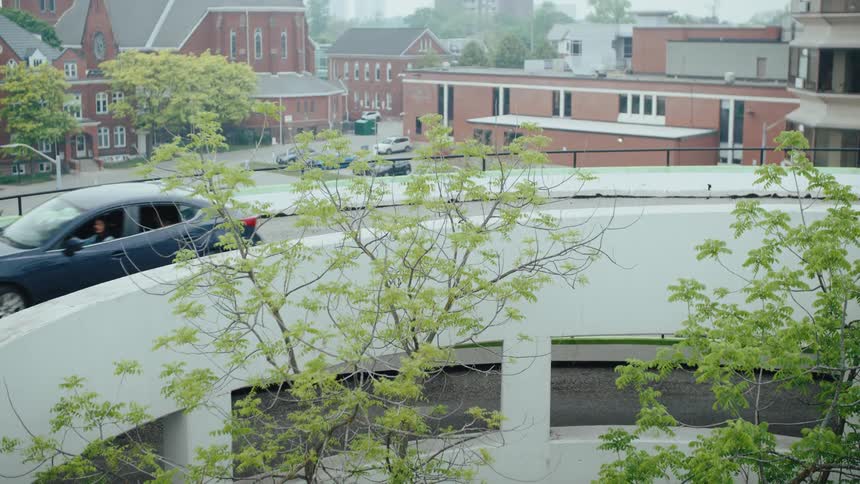 The car drives down the ramp in the parking garage