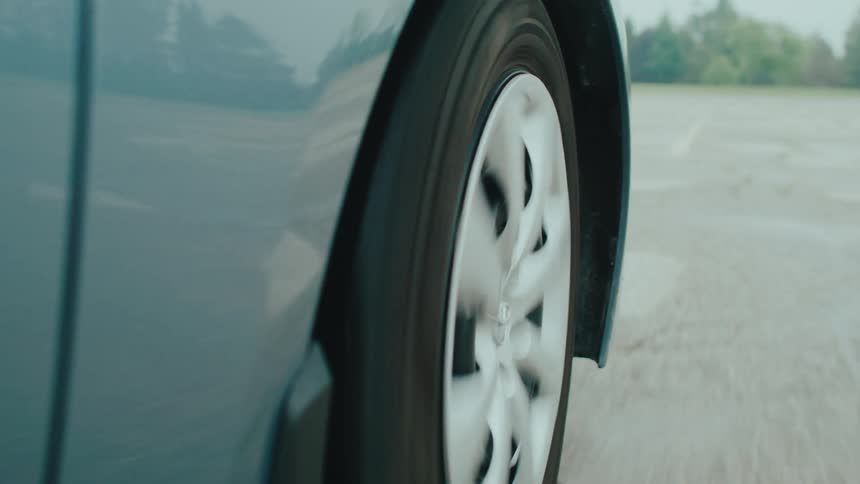 The car is driving in a circle in the parking lot