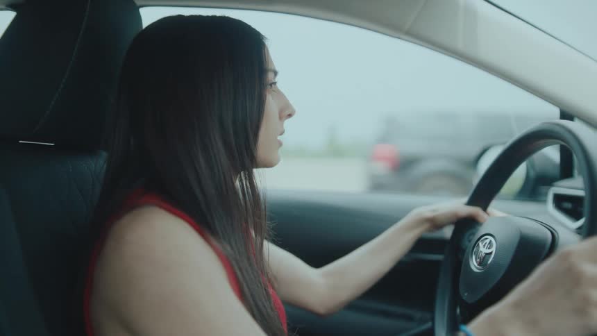Concentrated woman driving a vehicle