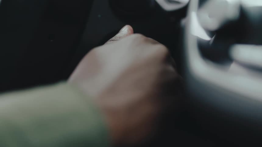 A car key dangles in the ignition after a person starts the ignition