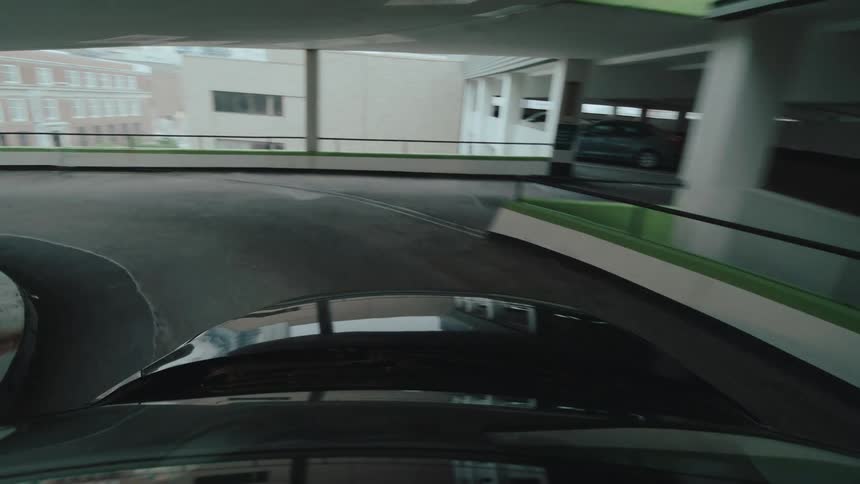 Point of view driving down exit ramp from indoor parking structure