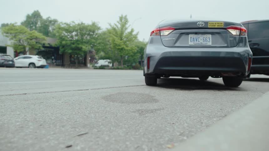 Sedan car reversing while parking the vehicle