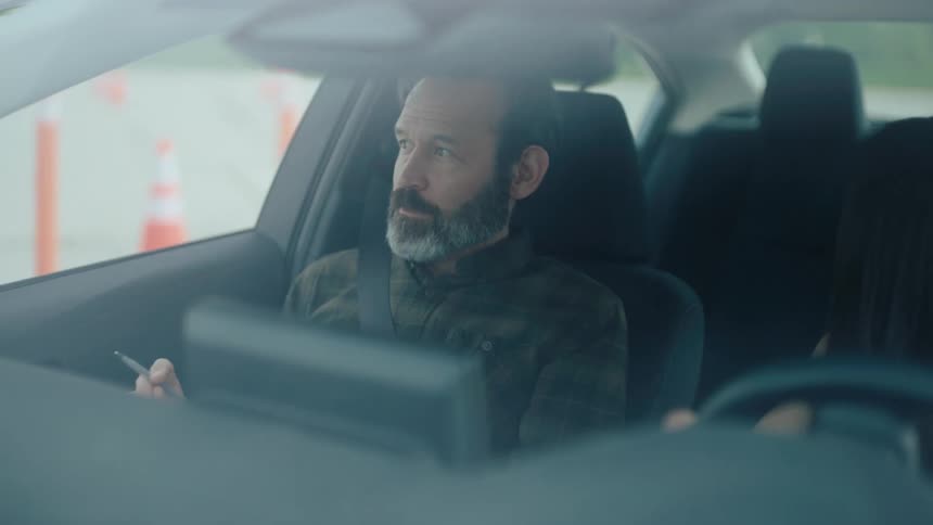 Woman driving in a test accompanied by a man