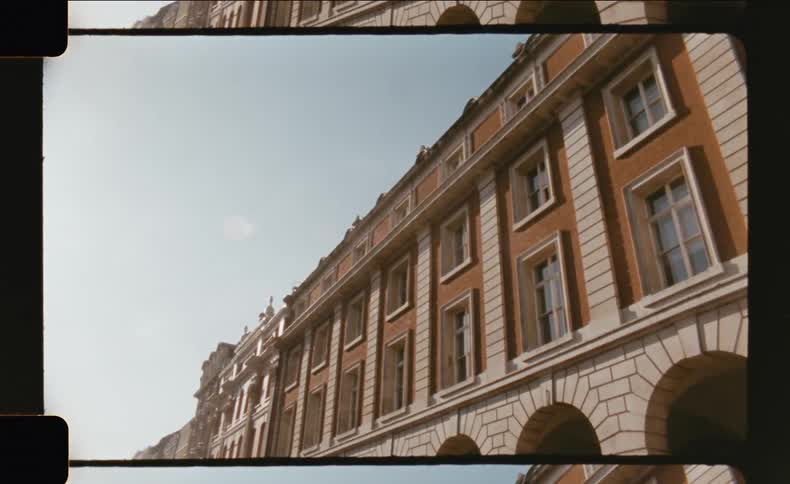 Classic urban building with patterned windows against a blue sky
