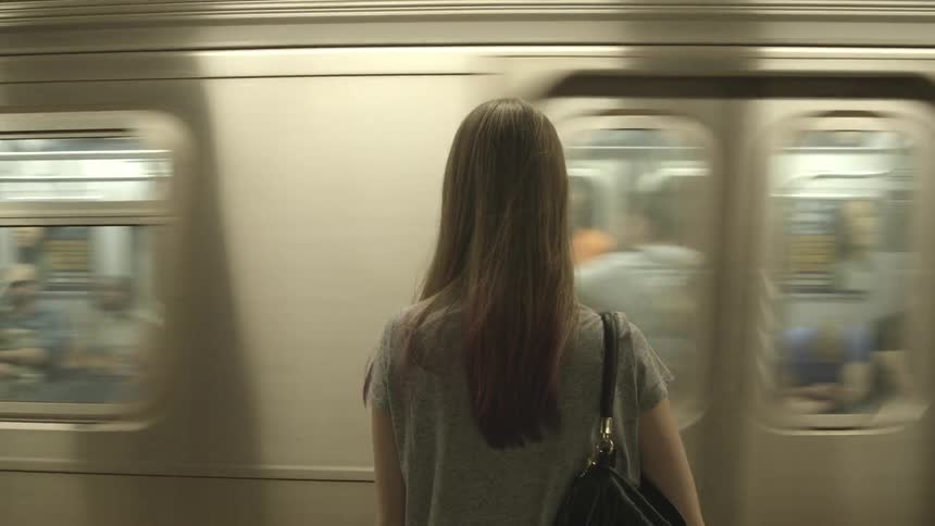 Woman waits for subway