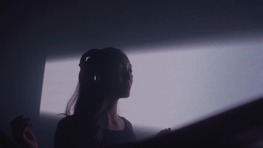 A black veil waves in front of the woman