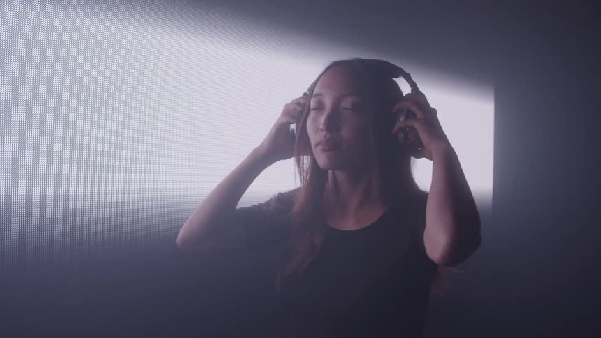 When the woman puts on her headphones the room fills with light