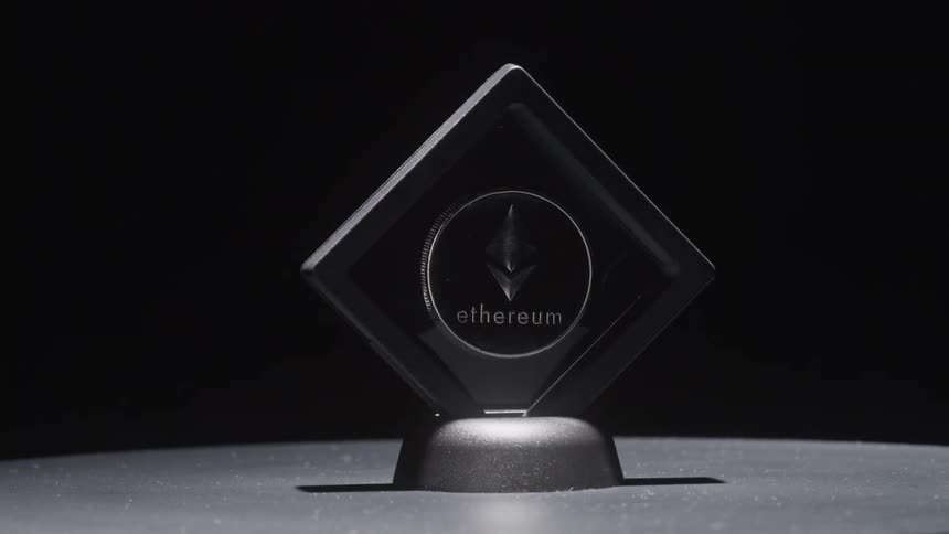 A cryptocurrency coin is spinning in a display