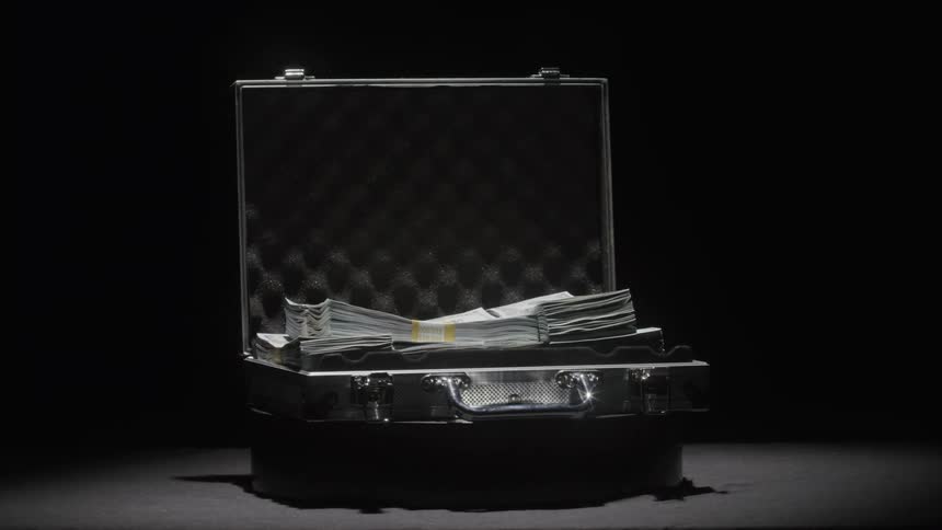 The briefcase is full of cash as the lights flicker