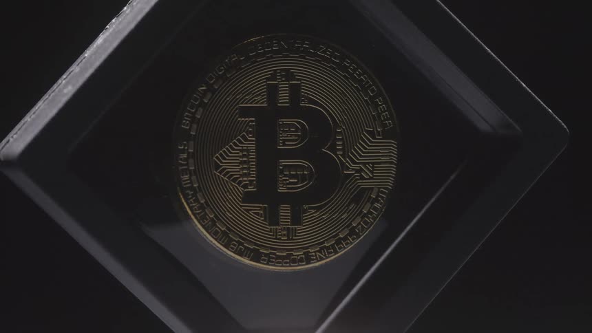 Close up of a golden bitcoin coin