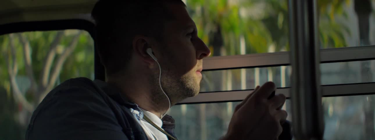 A man is taking photographs from a bus