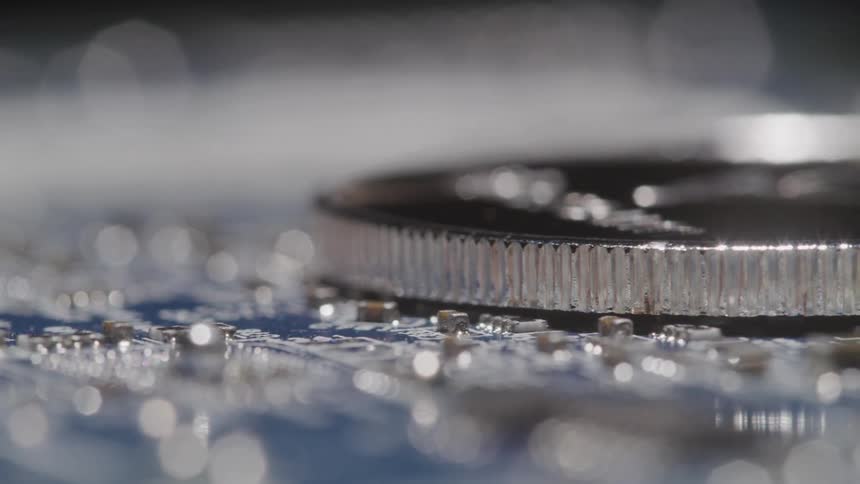 A coin on a circuit board spinning