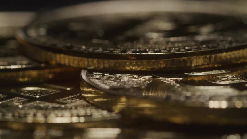 Close up of multiple physical digital coins stacked on a surface