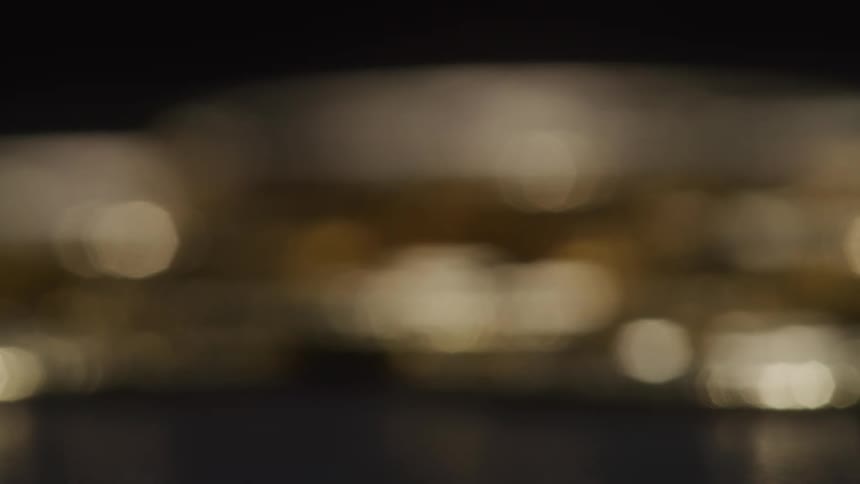 Blurred golden lights shimmer in a dark outoffocus scene