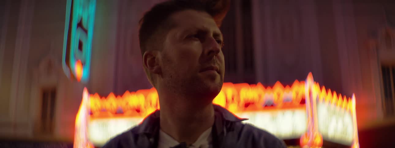 Man standing outside in city on windy night