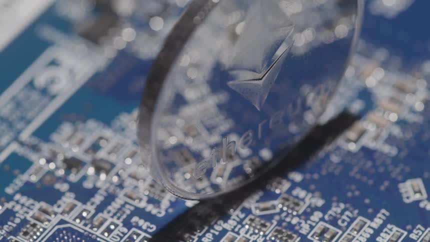 Ethereum coin reflects a blue and white circuit board