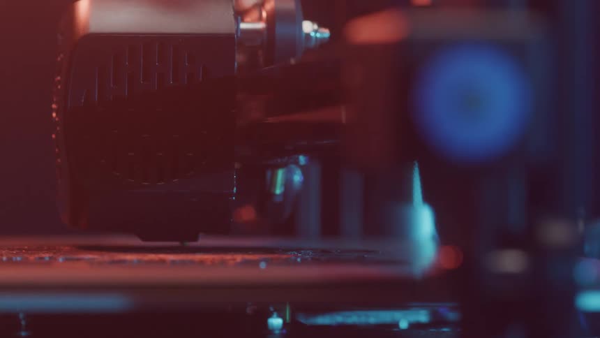 A robotic arm or industrial machine component is shown in closeup working with precision under dramatic red and blue lighting the scene highlights the intricate movements and mechanical efficiency of automated manufacturing