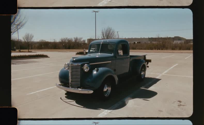 Vintage blue truck parked in a parking lot