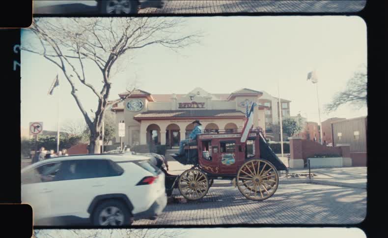A vintage carriage with a horse stands outside an old western style building