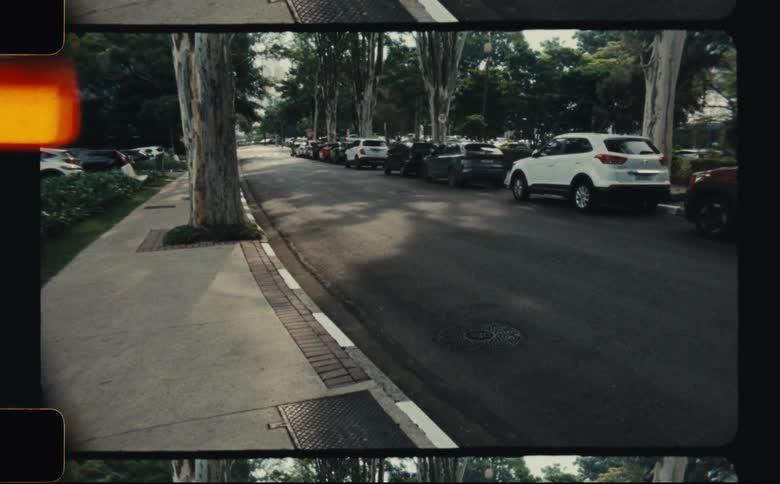 Parked cars are on the side of the road