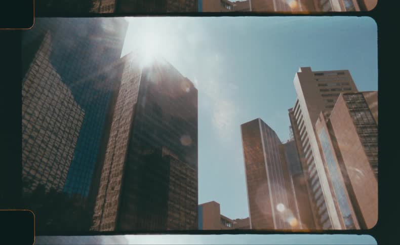 Sunlight shining between tall skyscrapers in a downtown cityscape