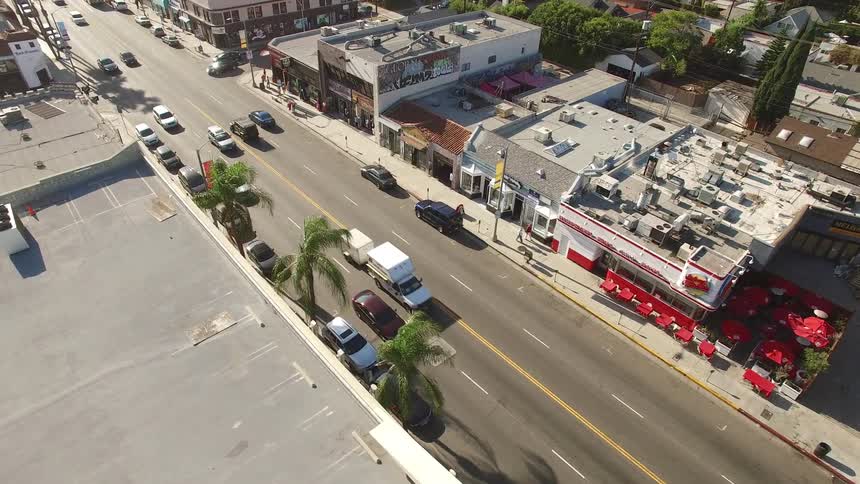 Cars drive down Melrose Avenue in Los Angeles