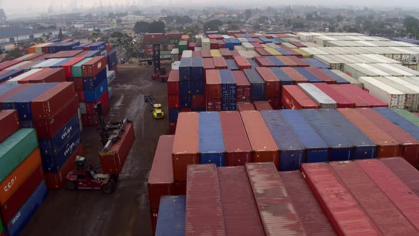 Hundreds of large shipping crates are stacked in a shipping yard
