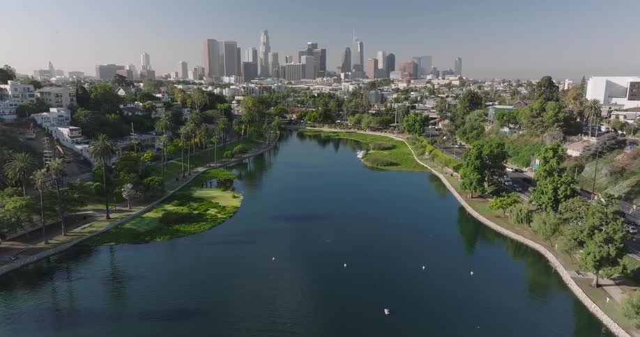A city stands in the distance of a river