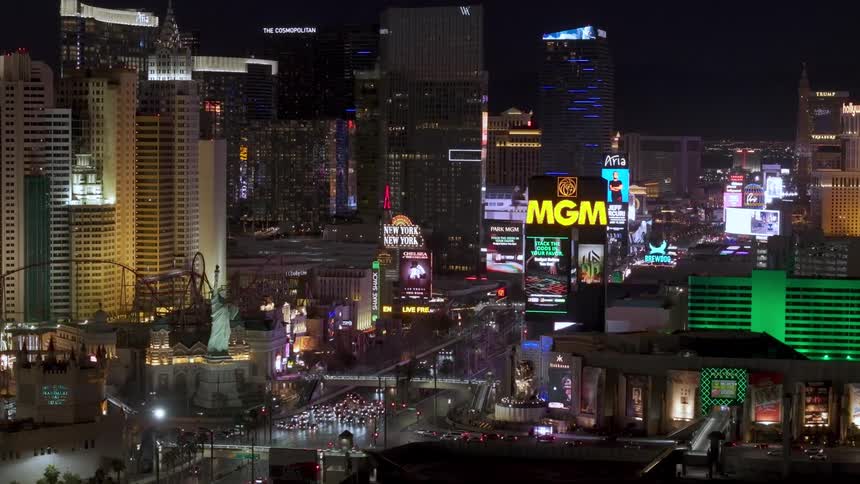 The cars are driving through the big city at night