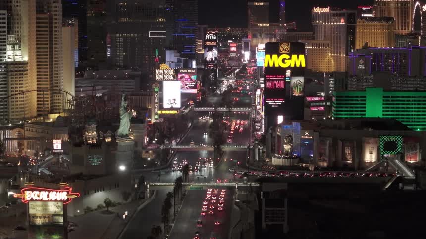 The las vegas strip glows with traffic and neon lights at night